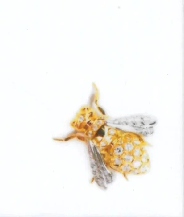 Gold Bee by Nelly in platinum gold and diamonds honeycomb pavé setting with pavé wings